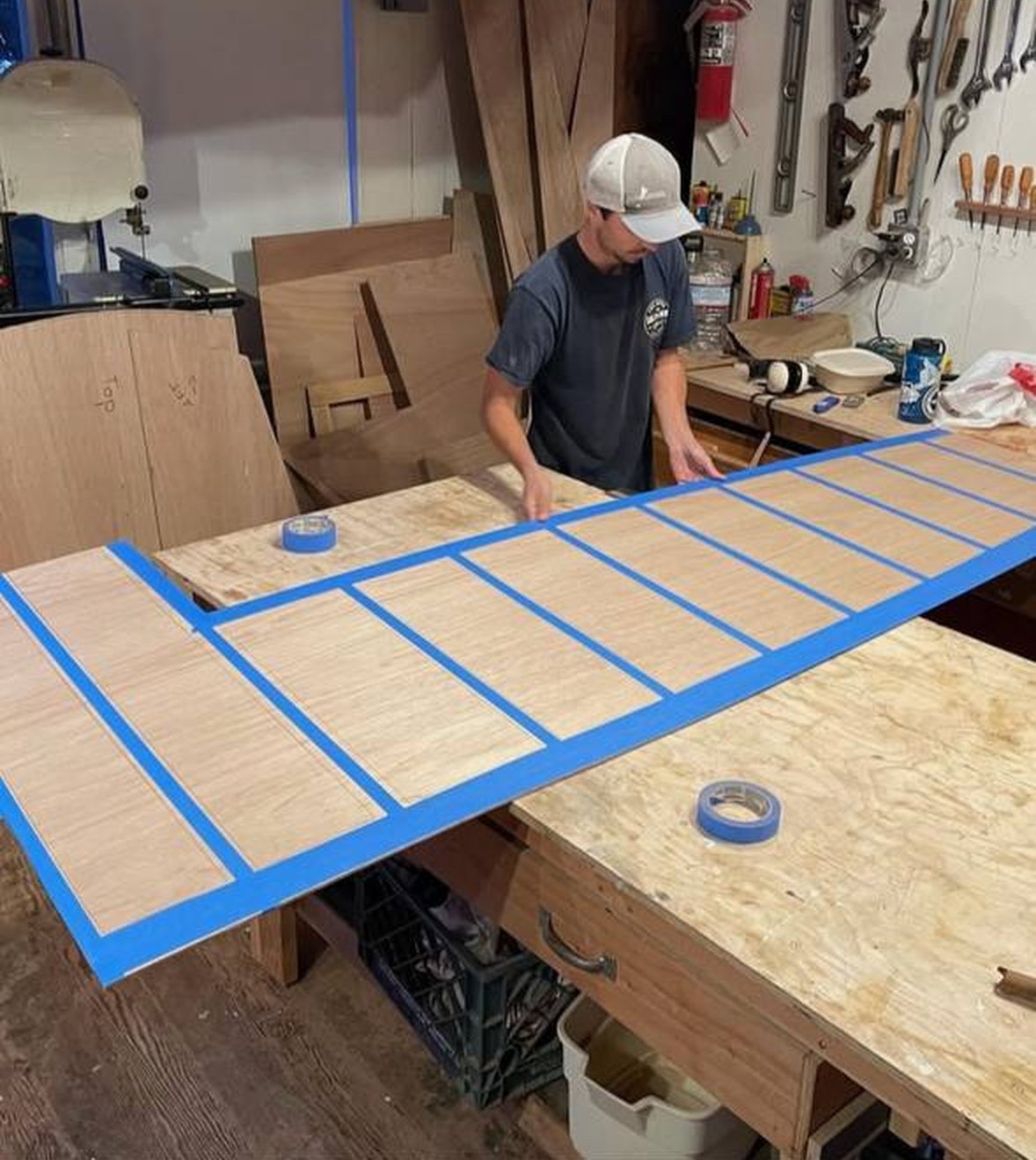 Sub-deck panels taped out on the bench before glass
